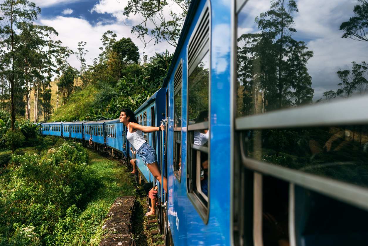 Chica asomada en pleno trayecto en un tren en la India